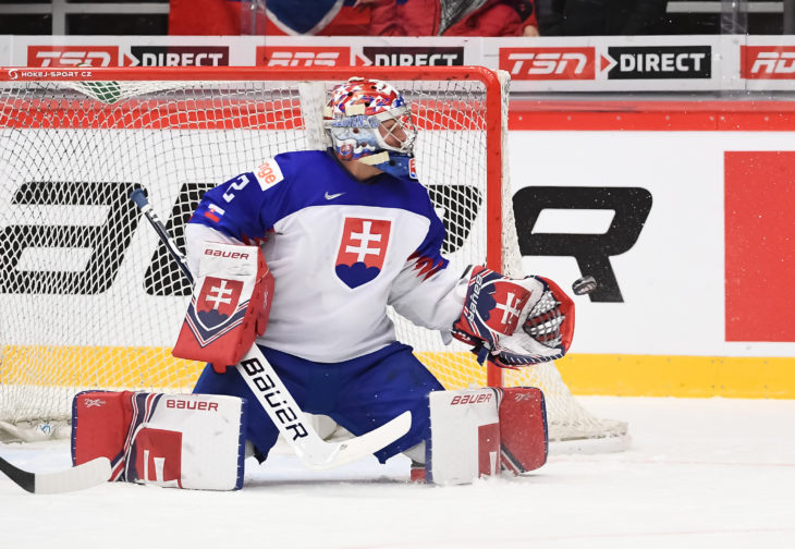 TRINEC, CZECH REPUBLIC - DECEMBER 30: Switzerland's Gilian Kohler #27 shoots the puck against Samuel Hlavaj #2 during preliminary round action at the 2020 IIHF World Junior Championship at Werk Arena on December 30, 2019 in Trinec, Czech Republic. (Photo by Matt Zambonin/HHOF-IIHF Images)